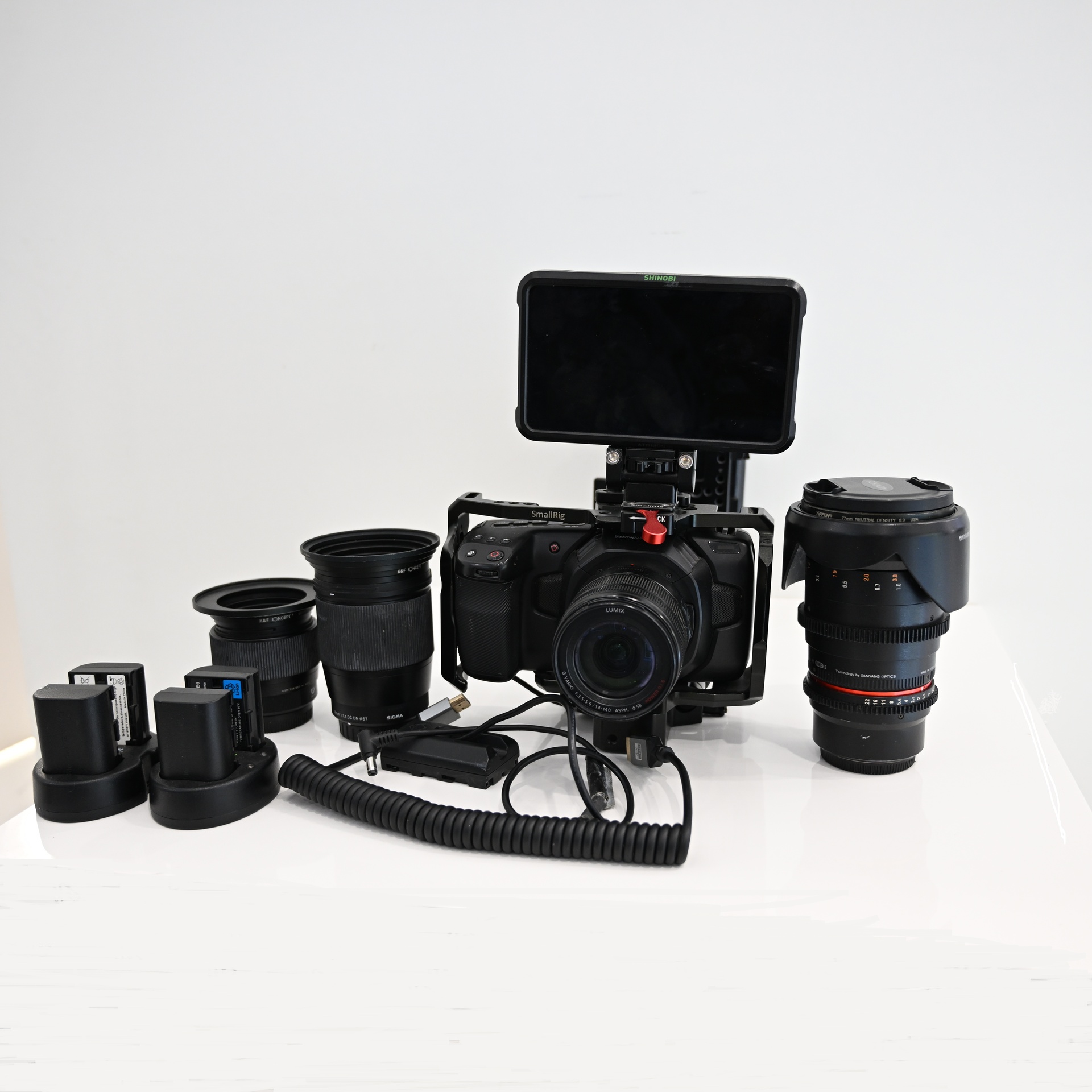 USED Blackmagic Pocket Cinema Camera 4K (BUNDLE) with Panasonic Lumix G Vario 14-140mm f/3.5-5.6 + Rokinon 35mm T1.5 Cine DS Lens + Sigma 16mm F1.4 DC DN for MFT + Sigma 56mm F1.4 DC DN for MFT + Ninja Shinobi Monitor + V Mount Battery and cage