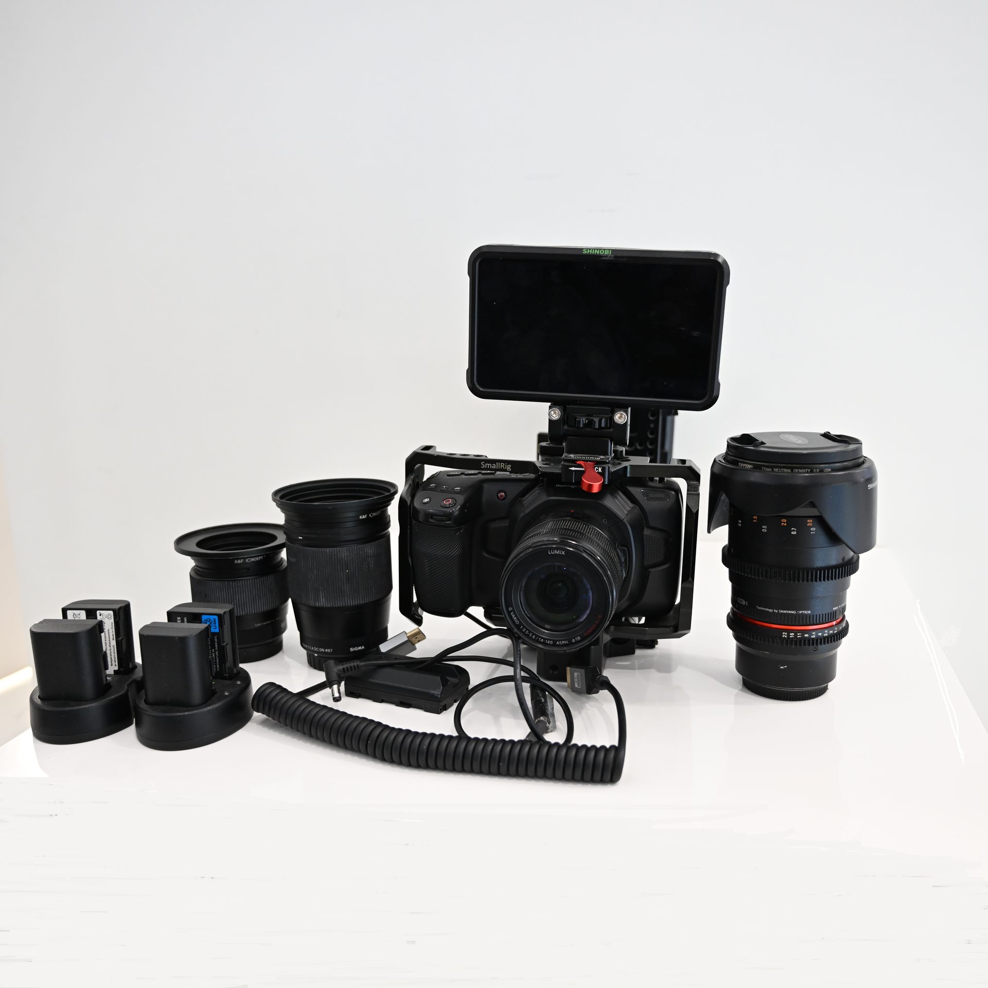 USED Blackmagic Pocket Cinema Camera 4K (BUNDLE) with Panasonic Lumix G Vario 14-140mm f/3.5-5.6 + Rokinon 35mm T1.5 Cine DS Lens + Sigma 16mm F1.4 DC DN for MFT + Sigma 56mm F1.4 DC DN for MFT + Ninja Shinobi Monitor + V Mount Battery and cage