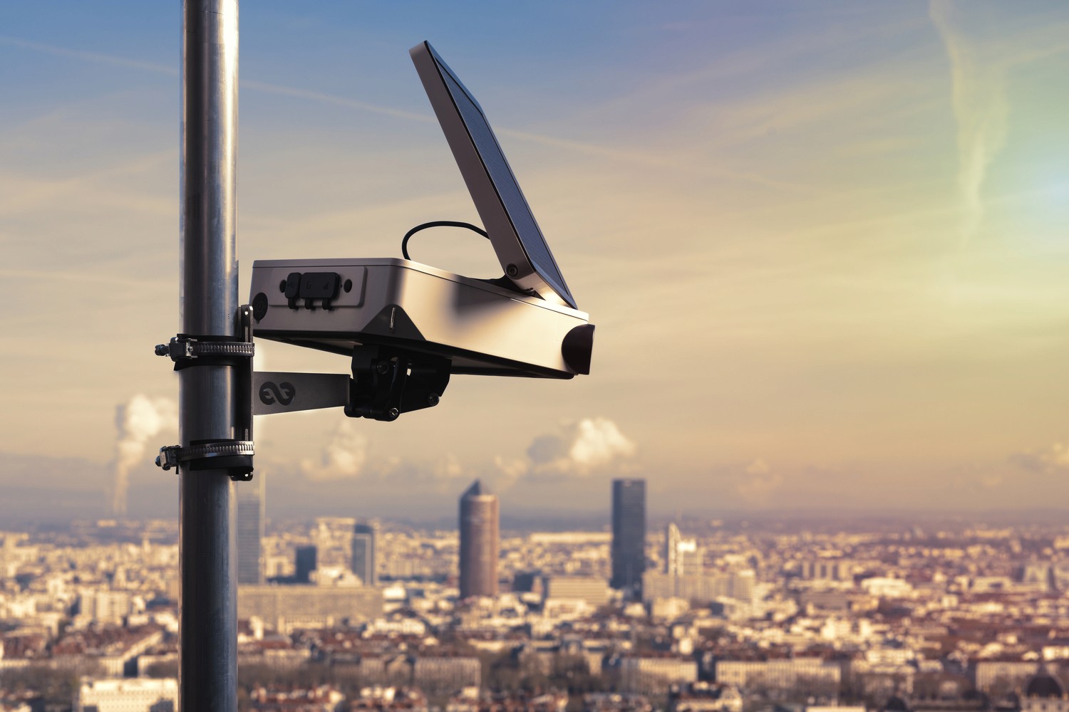 Enlaps Tikee timelapse camera mounted on site overlooking a city skyline
